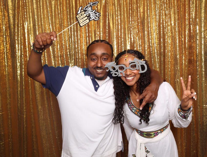 Graduation props and gold backdrop